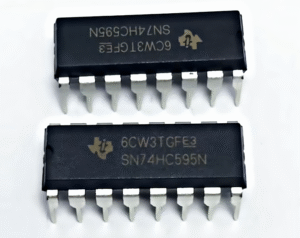 PCB Repair 21 Two black SN74HC595N 16-pin DIP integrated circuit chips with metallic pins visible, one showing the top view and the other inverted.