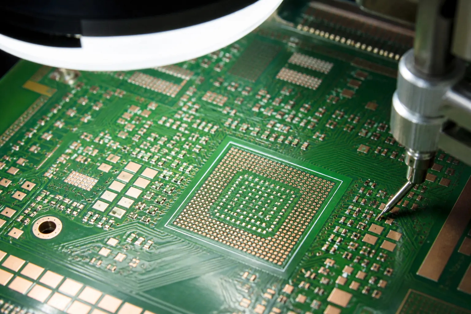 Macro manufacturing view of a PCB showing solder mask dams, dense pads, and inspection equipment over the board.